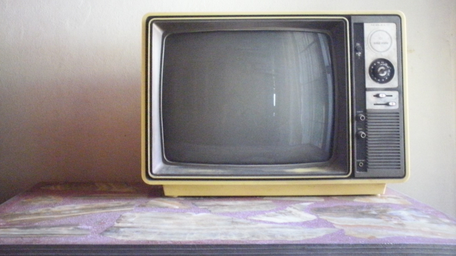 A small cathode ray tube television with a rotary tuning control.